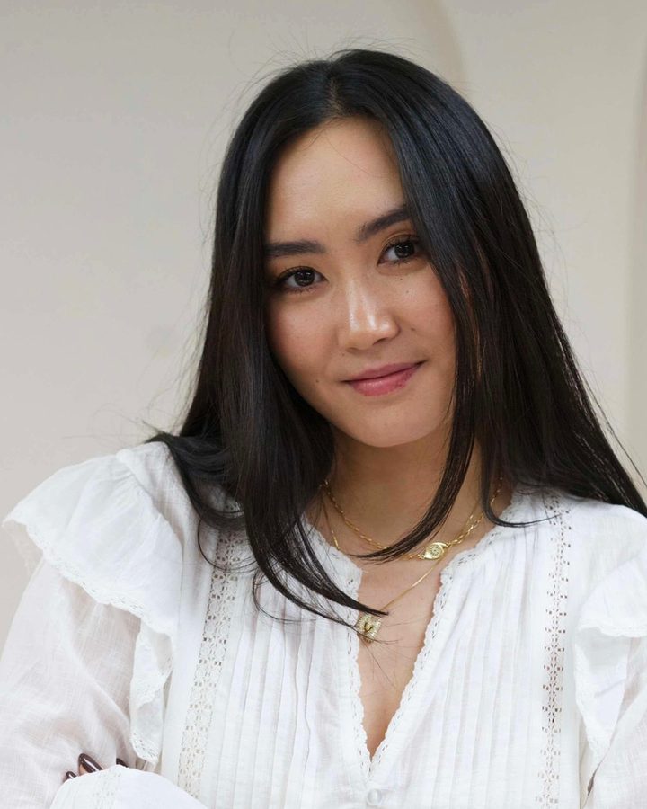 Mugi, smiling, in a white blouse